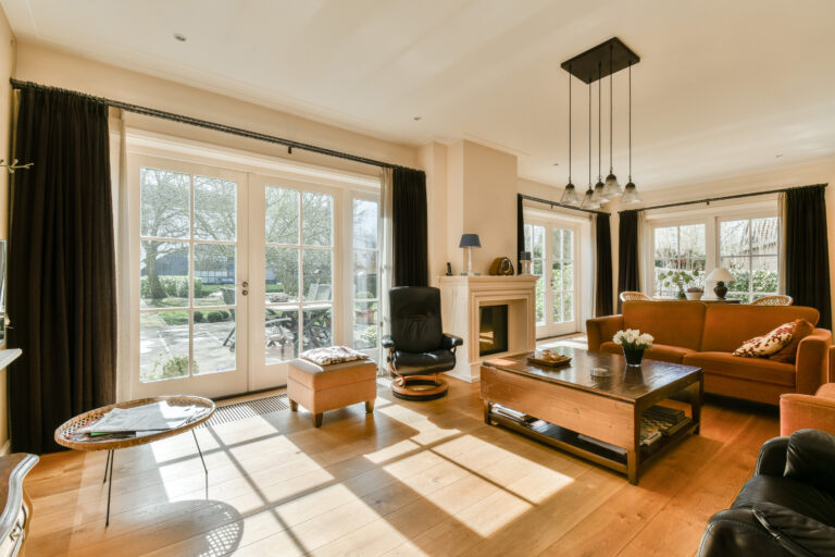 a living room with a fireplace and a large window